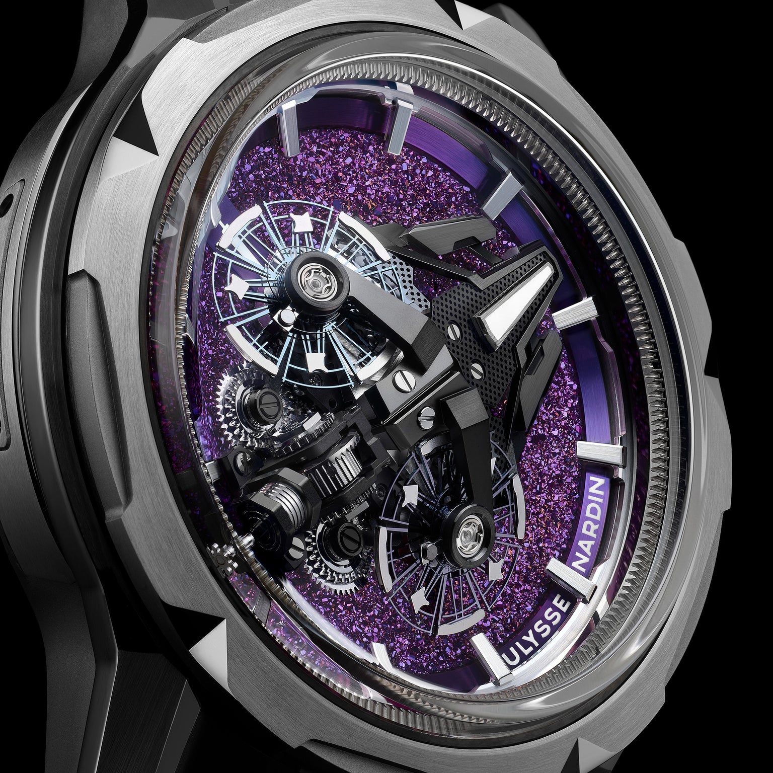 Close-up of the Ulysse Nardin Freak S WOS Centenary Exclusive wristwatch with a metallic case, exposed gears, and a shimmering purple dial—a true masterpiece from the Freak collection.