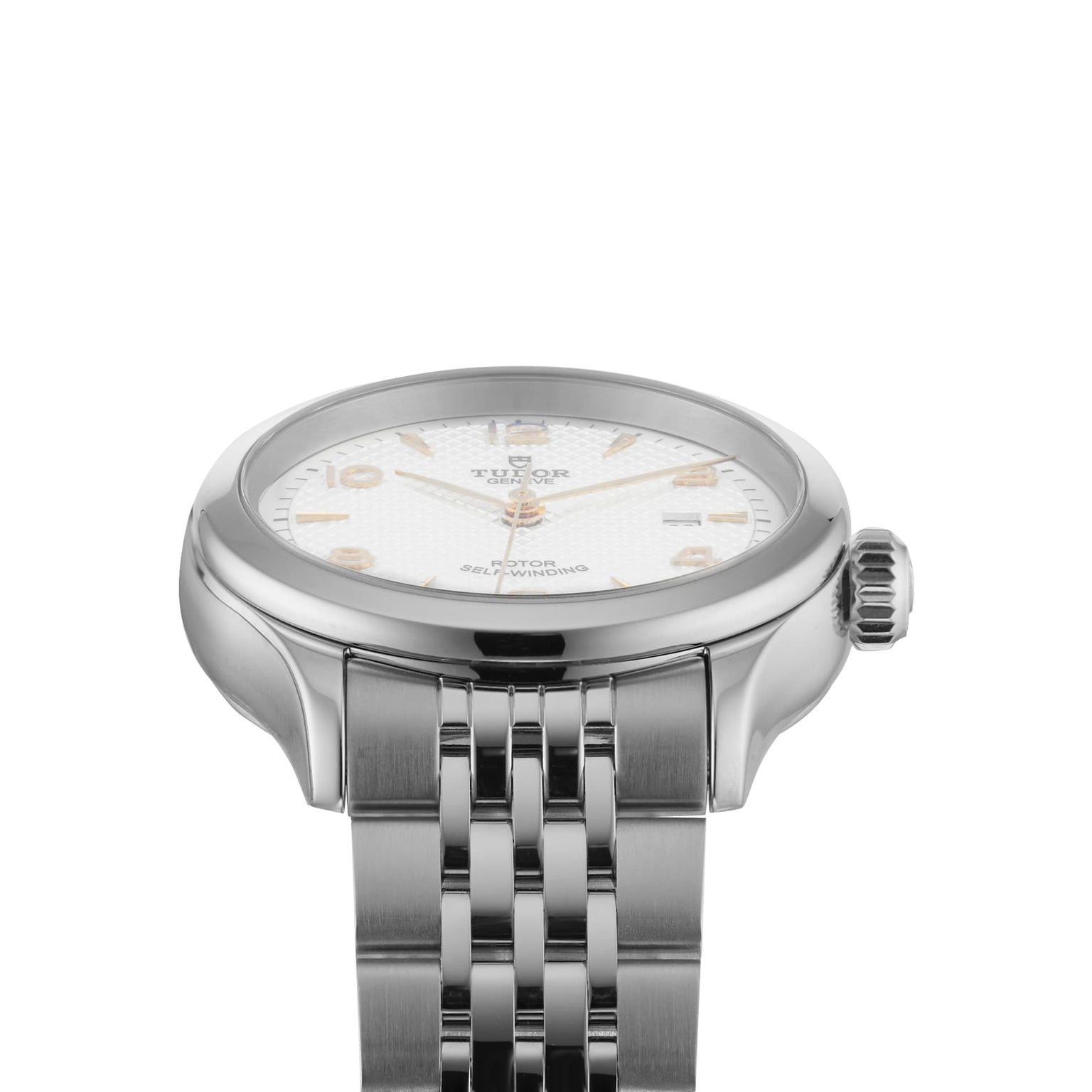 A close-up of a TUDOR 1926 ladies’ wristwatch featuring a silver case, white textured dial with gold hour markers, stainless steel bracelet, and self-winding mechanical movement.