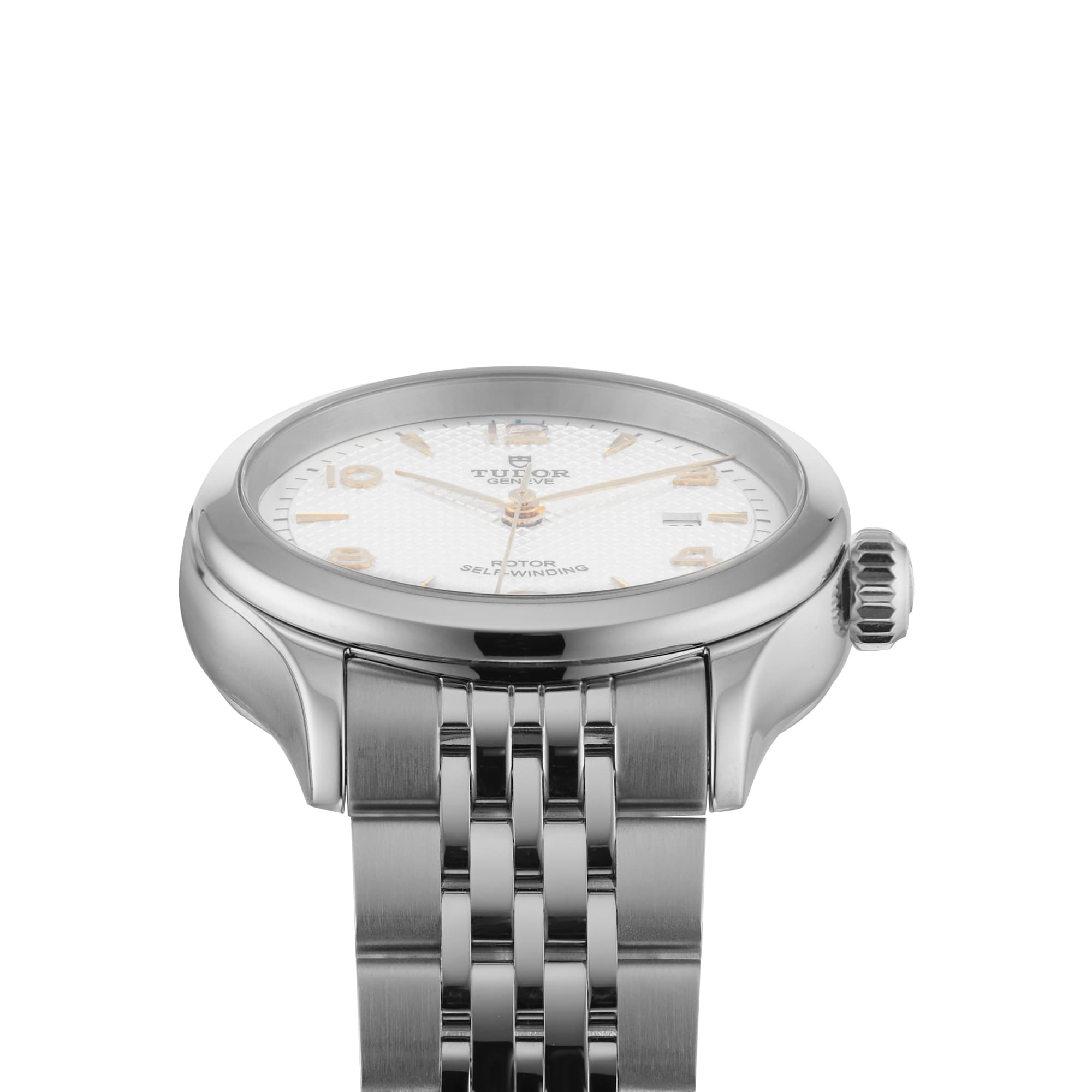 A close-up of a TUDOR 1926 ladies’ wristwatch featuring a silver case, white textured dial with gold hour markers, stainless steel bracelet, and self-winding mechanical movement.