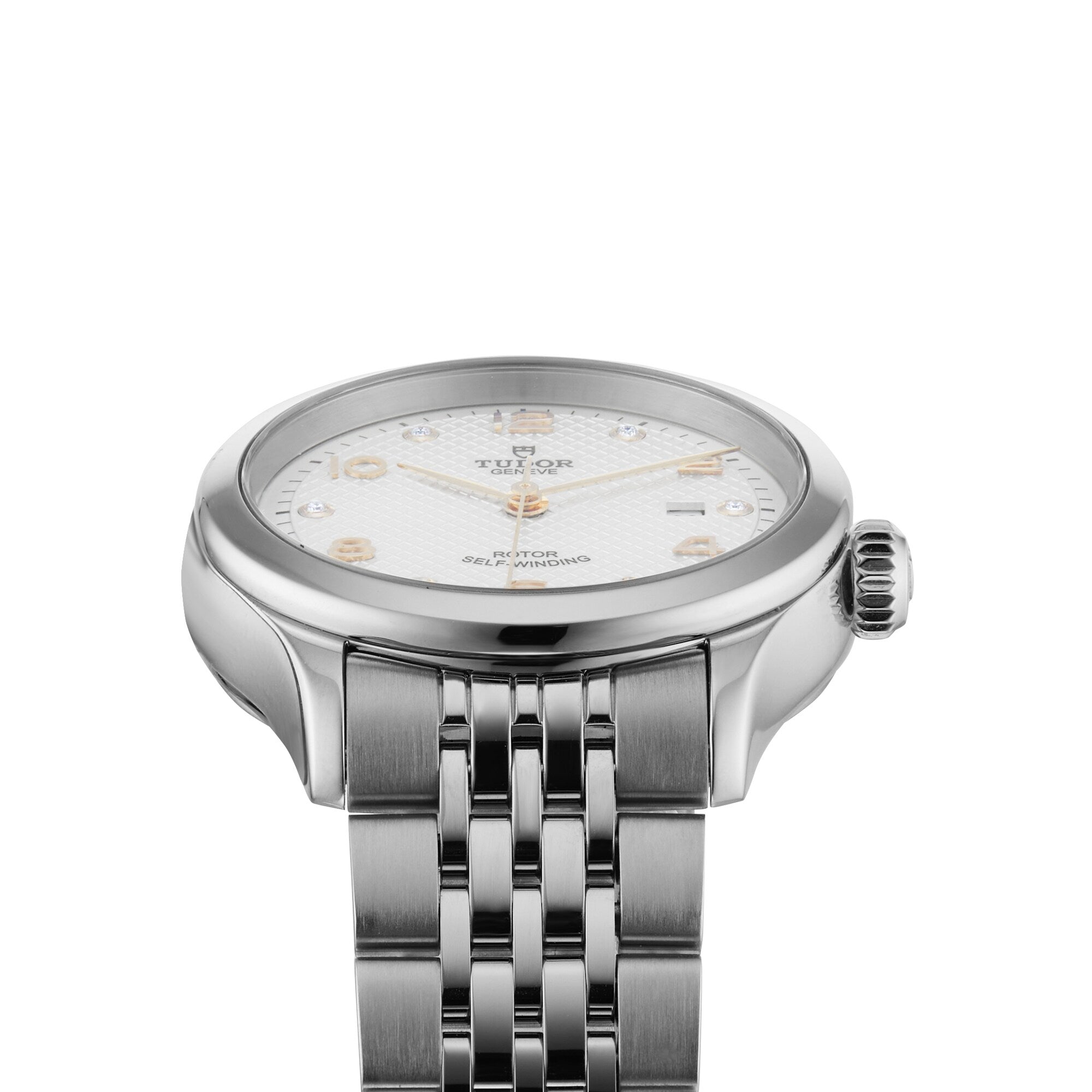 A close-up of the TUDOR 1926, a silver wristwatch with a white textured dial, diamond hour markers, and stainless steel bracelet, featuring a self-winding movement, photographed on a white background.