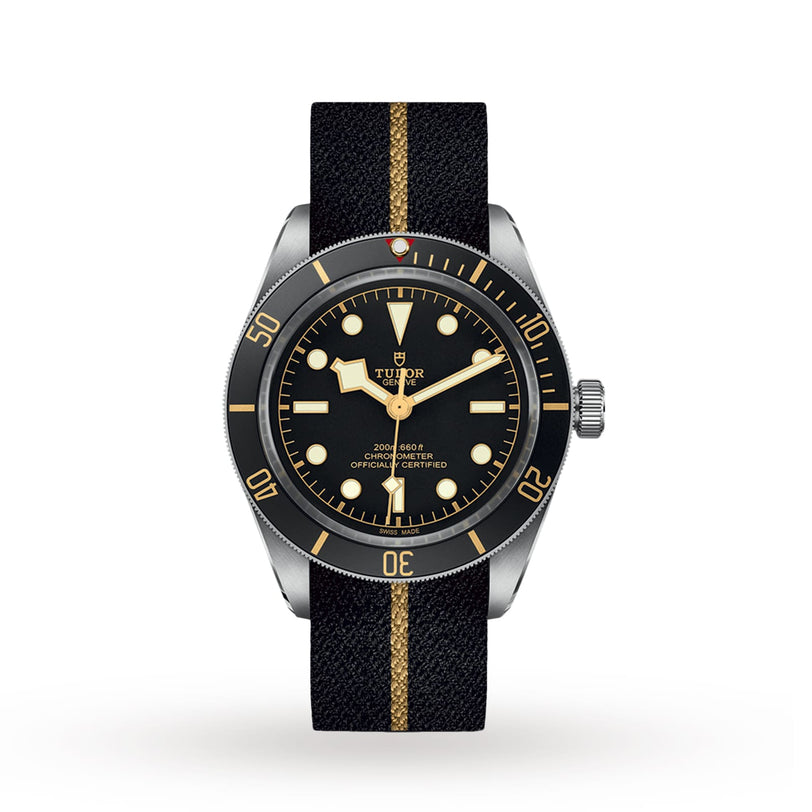 The TUDOR Black Bay 58 features a black dial with gold accents and a black fabric strap with a gold stripe, offering classic diver’s style and precise mechanical movement.