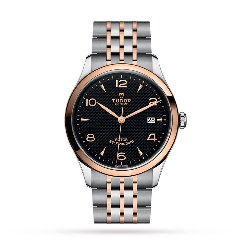 The TUDOR 1926 features a black textured dial, gold hour markers, date display, and a two-tone silver and gold bracelet—a refined timepiece blending timeless style with TUDOR’s renowned precision.