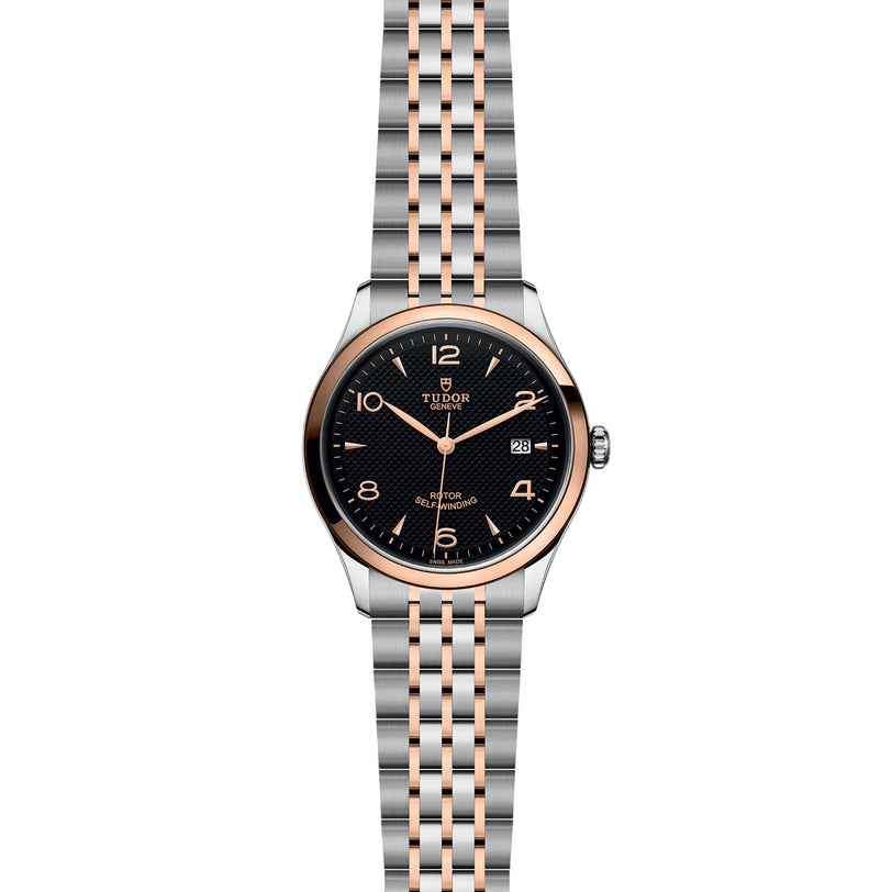 A TUDOR 1926 wristwatch with a black dial, gold hour markers, date display, and a two-tone silver and gold bracelet—a refined mechanical timepiece from the acclaimed TUDOR collection.