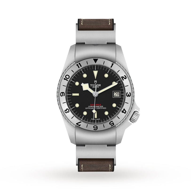 The TUDOR Black Bay P01 features a black dial, luminous markers, signature snowflake hands, date at 3 o’clock, stainless steel case, and brown leather strap, displayed against a plain white background.