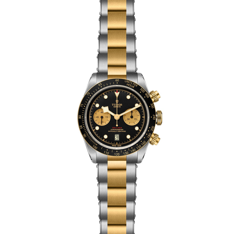 The TUDOR Black Bay Chrono S&G wristwatch features a two-tone metal band, black dial with gold subdials and markers, signature snowflake hands, and a tachymeter bezel.