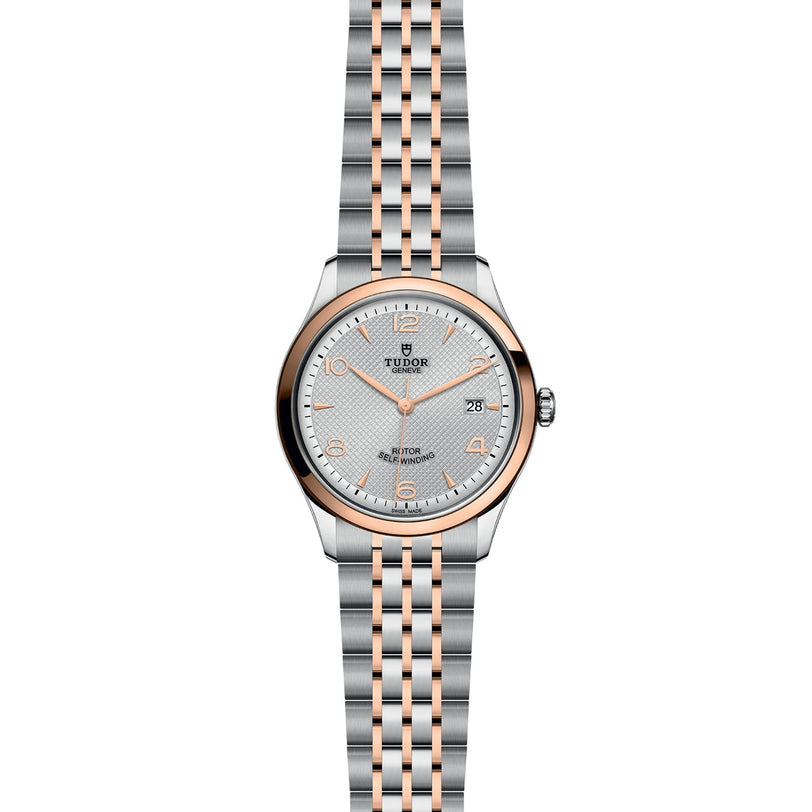 The TUDOR 1926 wristwatch features a round face, metal link bracelet, date display, and simple indices on a textured dial—an elegant choice for classic mechanical watch enthusiasts.