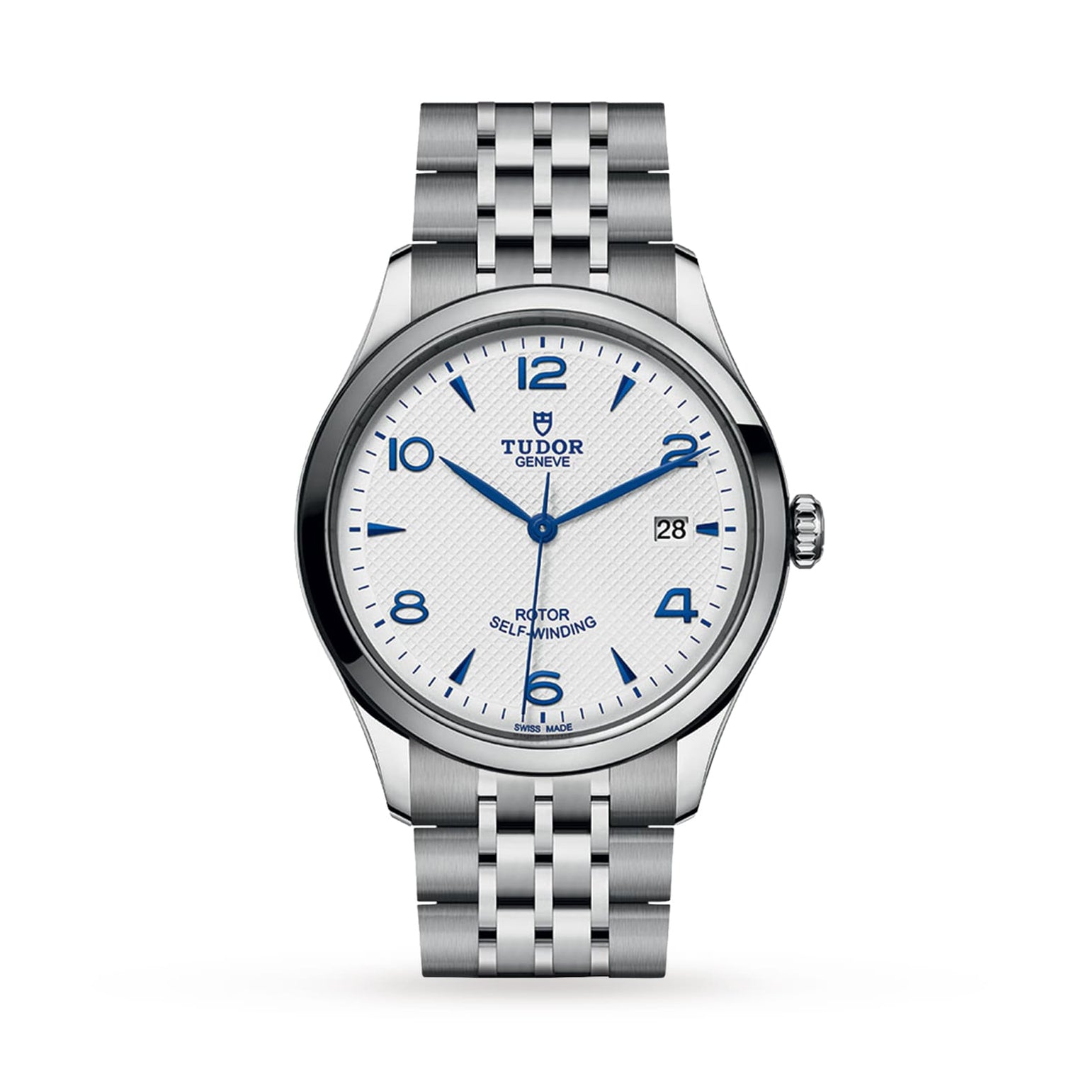 The TUDOR 1926 is a stainless steel wristwatch with a white textured dial, blue Arabic numerals and hands, a date display at 3 o’clock, and a polished silver bracelet that showcases TUDOR’s mechanical watch expertise.