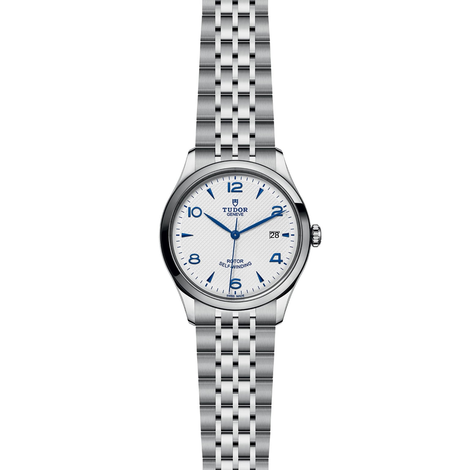 The TUDOR 1926 is a stainless steel wristwatch with a white dial, blue Arabic numerals, date display at 3 o’clock, and metal link bracelet—an elegant mechanical timepiece.
