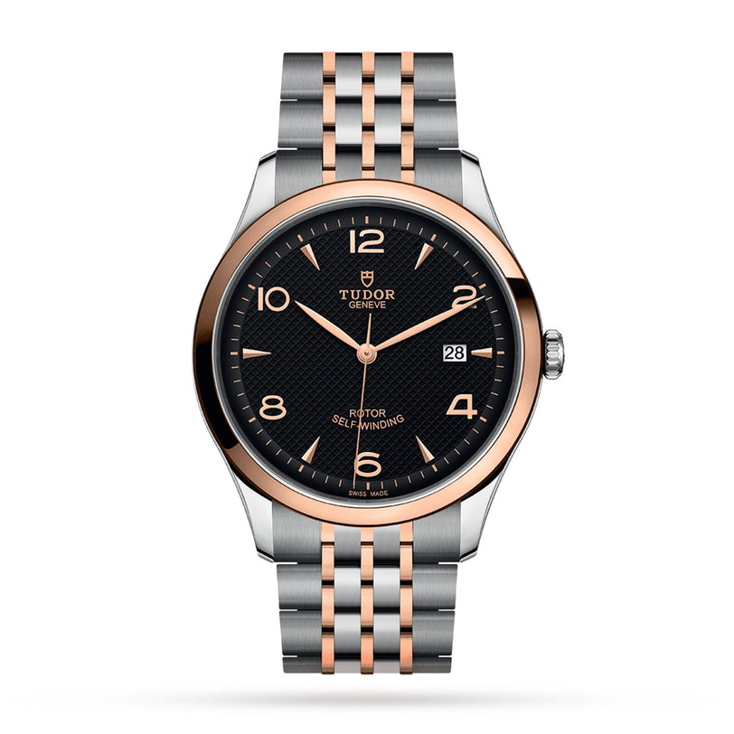 The TUDOR 1926 is a two-tone wristwatch with a black dial, gold accents, date display, and metal bracelet.