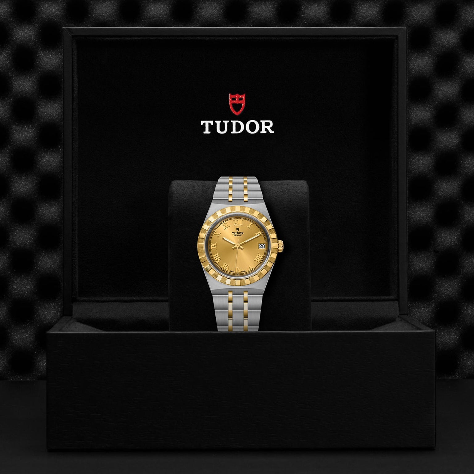 A TUDOR Royal wristwatch is presented in an open black box featuring the Tudor logo on the inside lid, highlighting the brands signature sport-chic style and automatic watch craftsmanship.