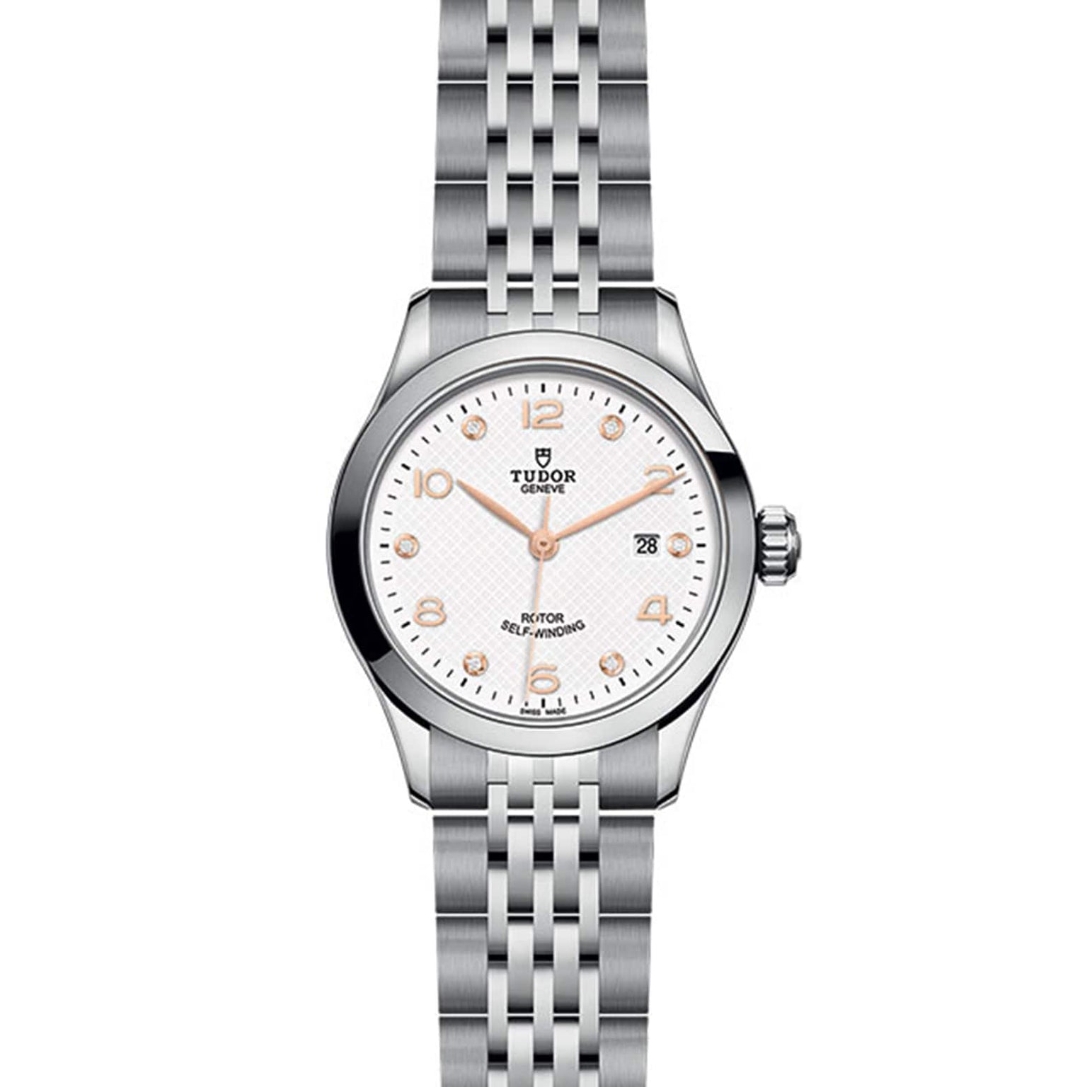 The TUDOR 1926 features a stainless steel case, white dial, silver hour markers, date at 3 o’clock, and metal link bracelet—an elegant tribute to TUDOR’s tradition of fine mechanical watches.