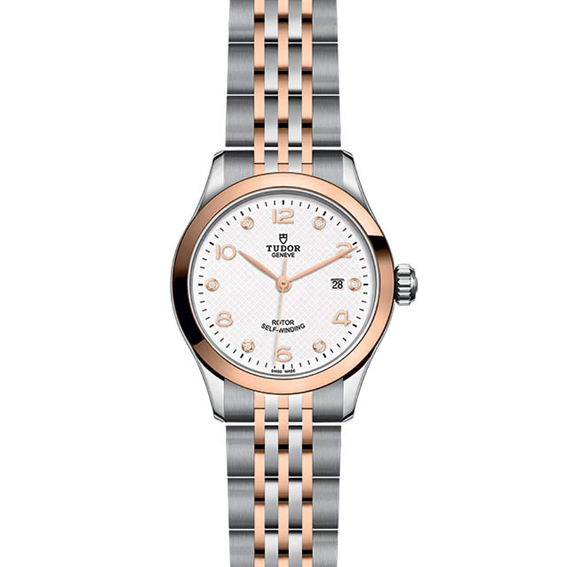 The TUDOR 1926 features a silver and rose gold two-tone band, white dial, gold hour markers, and a date display at 3 o’clock—an elegant wristwatch for refined tastes.