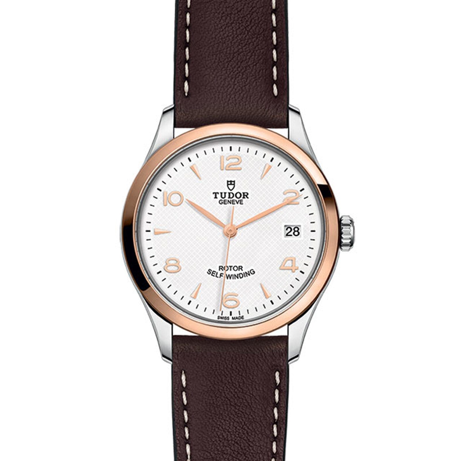 The TUDOR 1926 wristwatch features a white textured dial, gold-tone markers, date at 3 o’clock, brown leather strap, and a stainless steel and gold bezel—honoring the brand’s classic mechanical watch heritage.