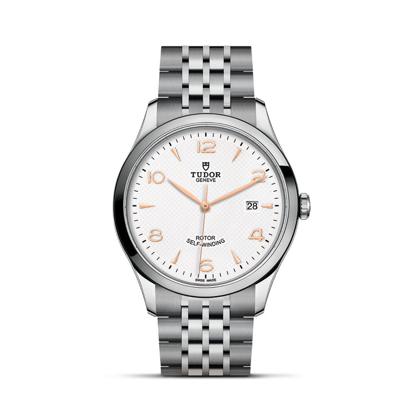 A silver TUDOR 1926 wristwatch with a white dial, gold hour markers, date display, and a stainless steel bracelet—an elegant tribute to mechanical watches inspired by the legacy of Rolex’s founder.