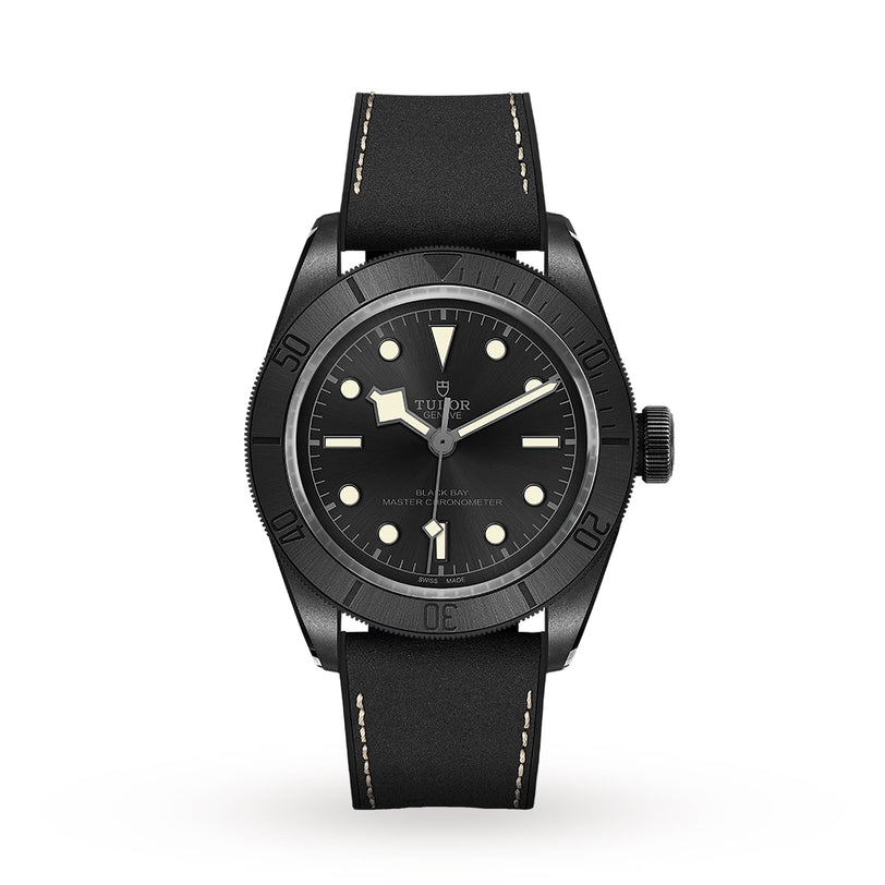The TUDOR Black Bay Ceramic wristwatch features a black bezel, black dial with luminous markers and hands, and a black leather strap with white stitching, all showcased on a white background—an example of Swiss-made craftsmanship.