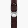 Close-up of a brown leather watch strap with white stitching and a silver clasp engraved with TUDOR—an elegant detail for the TUDOR 1926 watch.