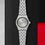 A TUDOR Royal wristwatch with a metal bracelet, silver dial, and date display is set on a textured black and red background, showcasing the refined sport-chic style of the Royal by TUDOR.