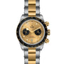 The TUDOR Black Bay Chrono S&G features a gold and silver bracelet, black bezel, and gold dial with two subdials.