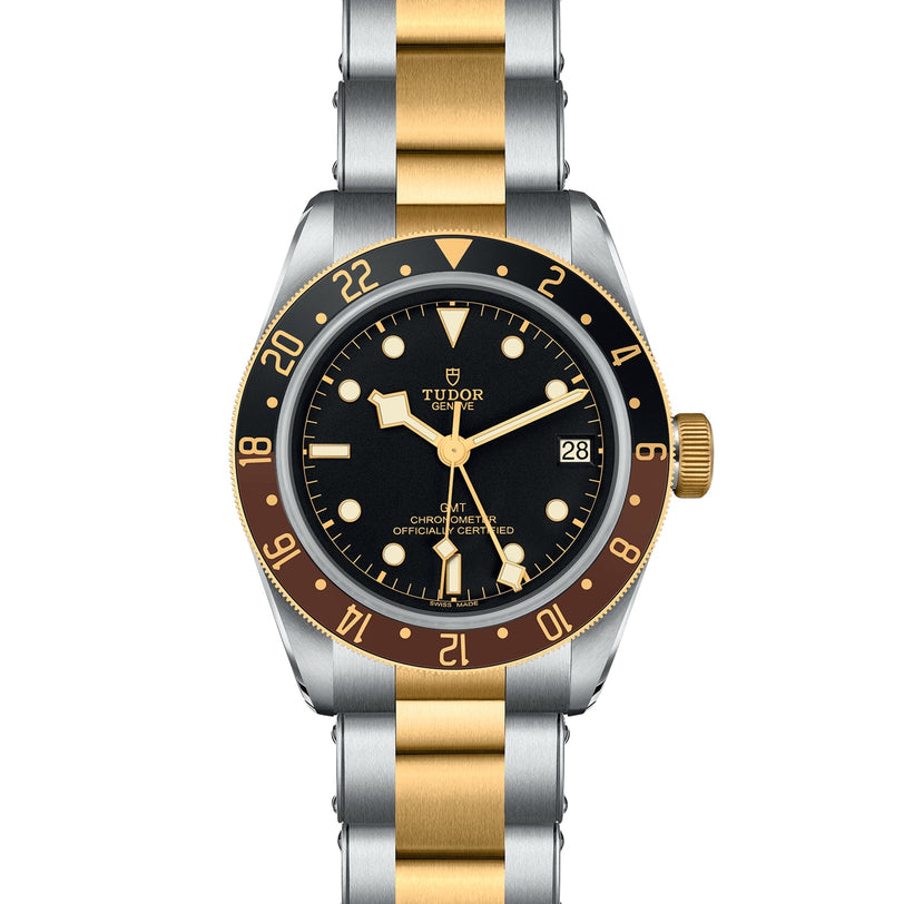 The TUDOR Black Bay GMT S&G features a black and brown bezel, black dial, yellow gold markers, date display, and a two-tone silver and gold metal bracelet inspired by classic Tudor divers’ watches.
