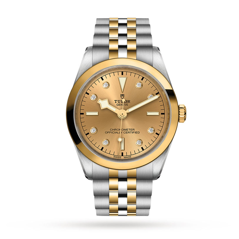 The TUDOR Black Bay One 36 S&G features a gold and silver bracelet, gold bezel, champagne dial, and diamond hour markers, shown on a white background.
