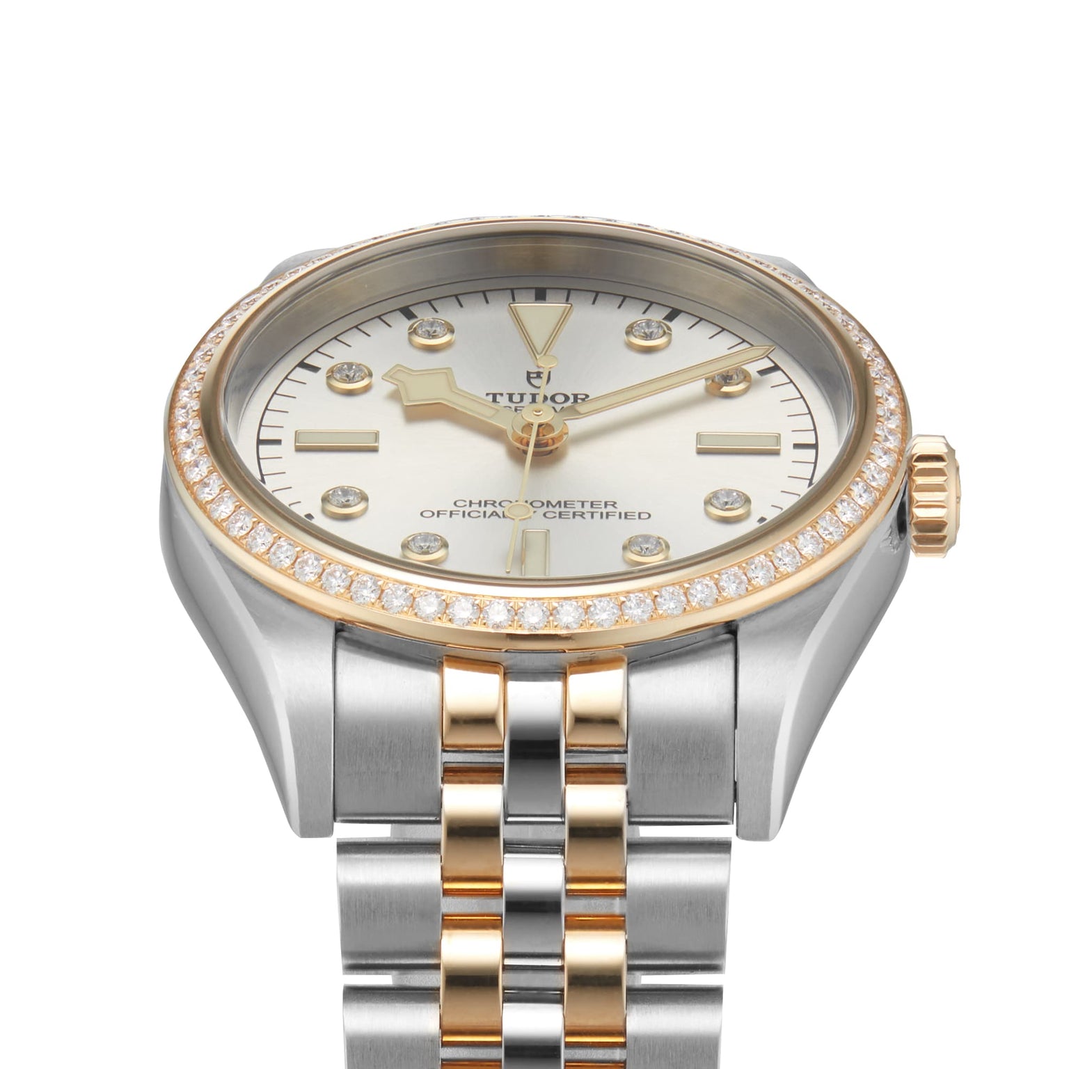 The TUDOR Black Bay One 36 S&G wristwatch features a silver and gold design with diamond bezel and markers, set on a metal link bracelet.