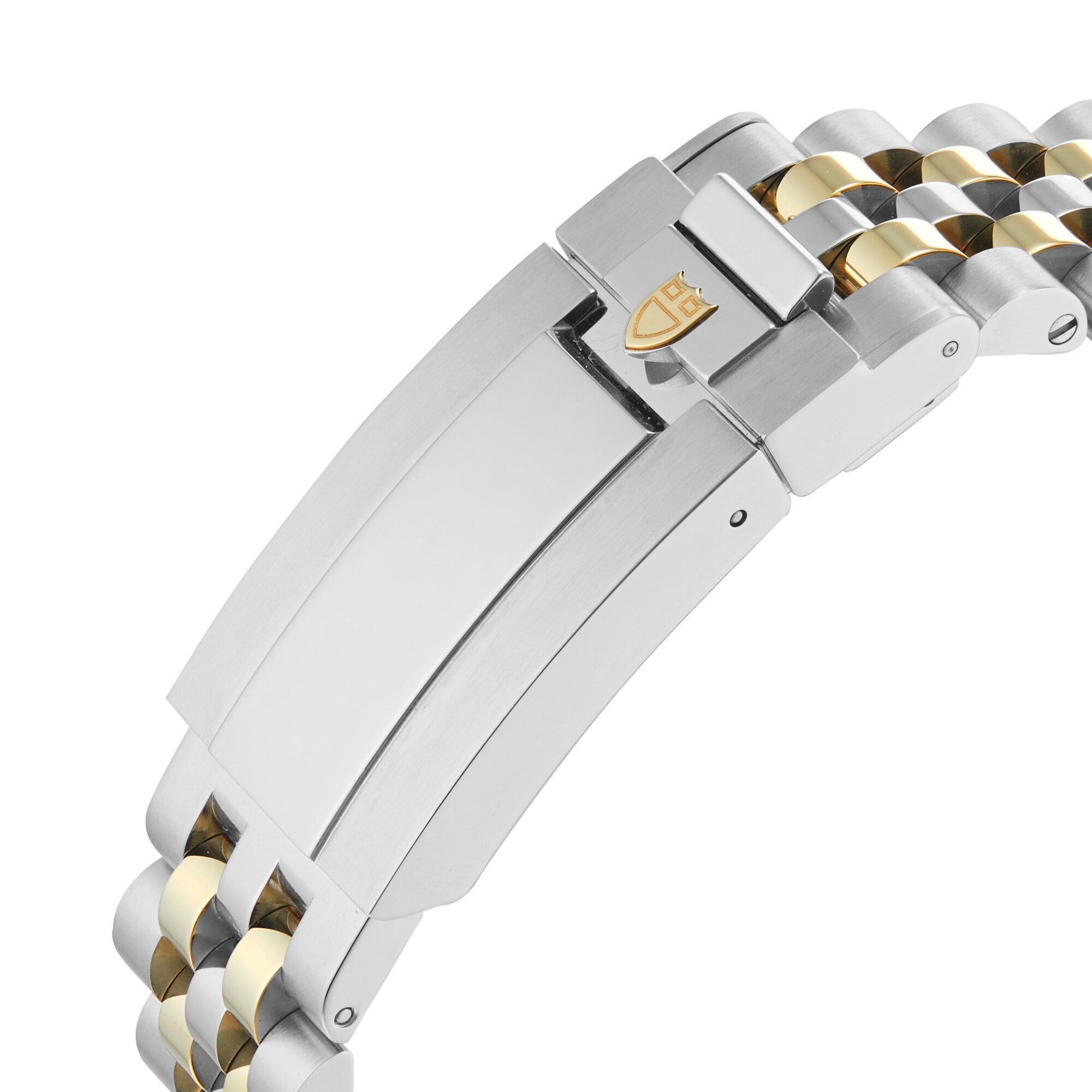 Close-up of a TUDOR Black Bay One 36 S&G stainless steel and yellow gold bracelet, showing a clasp with an engraved shield logo.