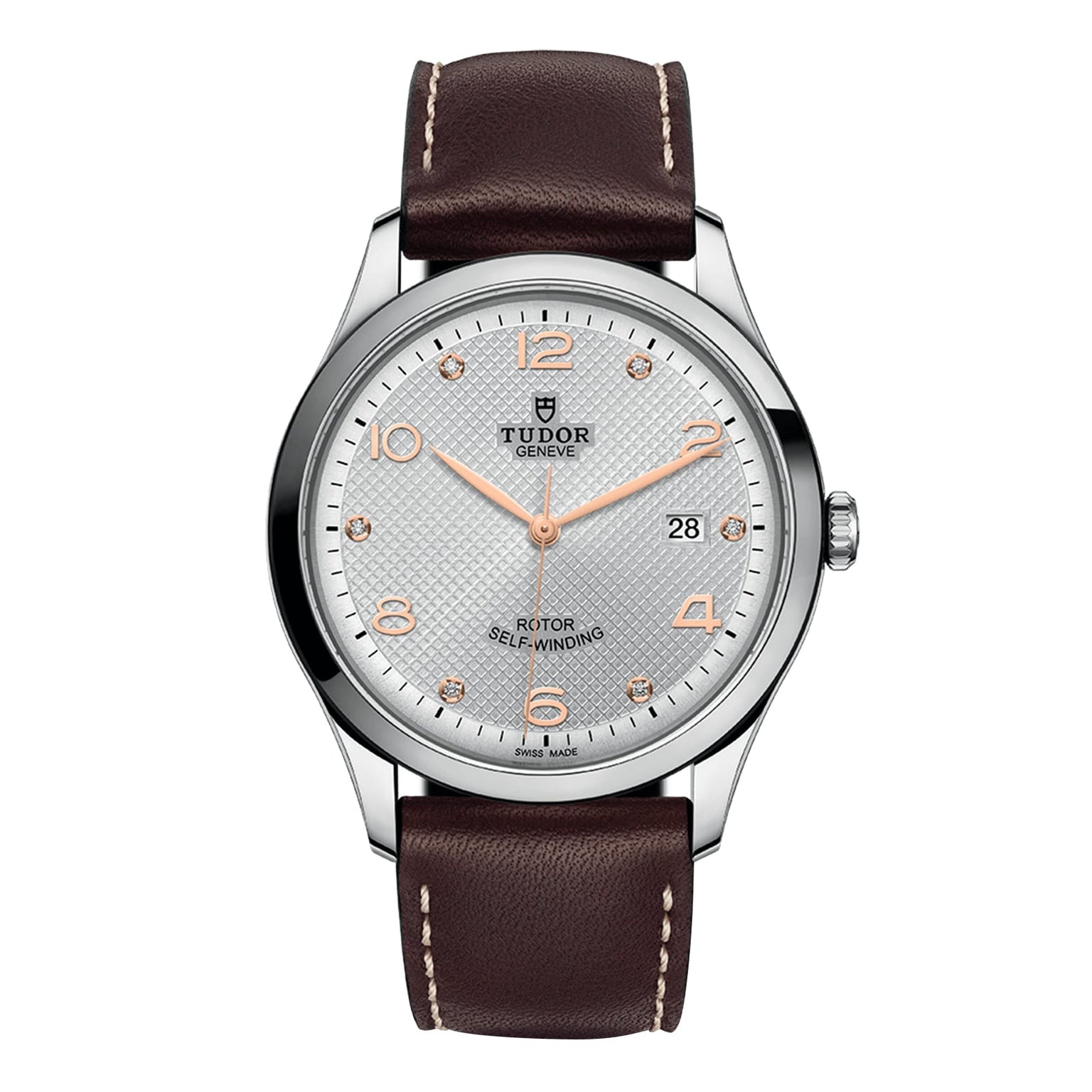 The TUDOR 1926 is a classic wristwatch featuring a silver dial, gold hour markers, mechanical movement, date at 3 o’clock, brown leather strap, and stainless steel case.