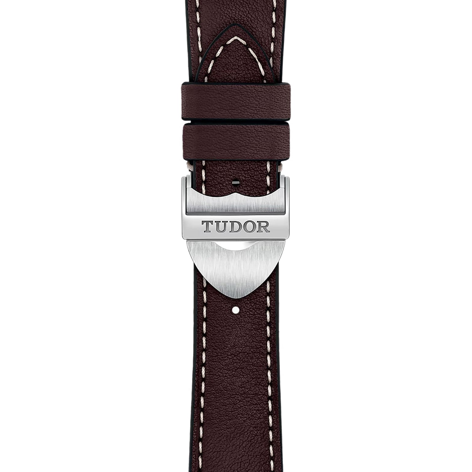 Close-up of a classic brown leather TUDOR 1926 watch strap, featuring white stitching and a silver clasp engraved with the Tudor logo.