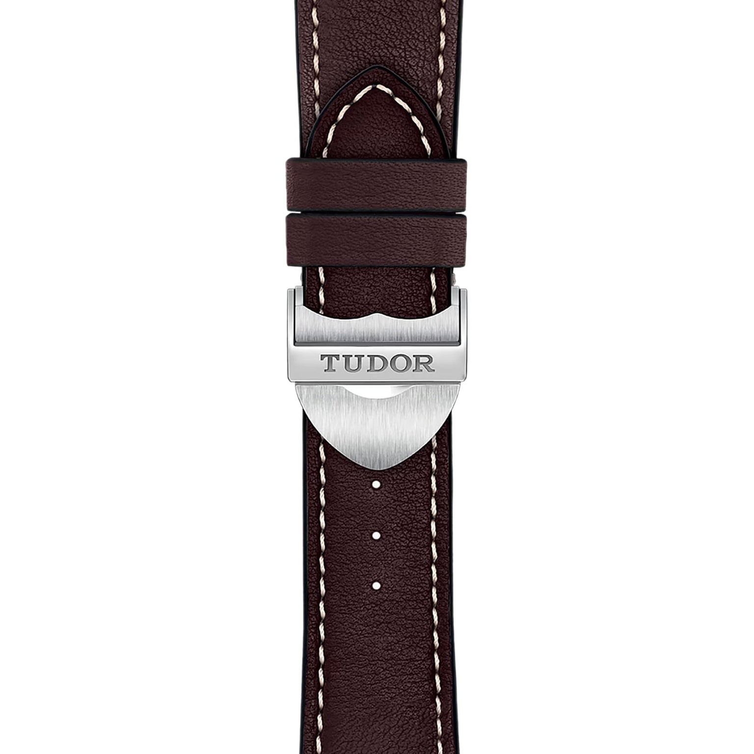 Close-up of a brown leather strap with white stitching and a silver buckle engraved with TUDOR, highlighting the classic design of the TUDOR 1926 watch.