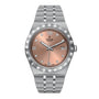 The TUDOR Royal wristwatch features a salmon dial with Roman numerals, diamond hour markers, automatic movement, and a date display at 3 oclock.
