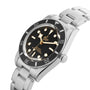 The TUDOR Black Bay 54 is a stainless steel wristwatch with a black dial and bezel, luminous markers, and a metal bracelet.