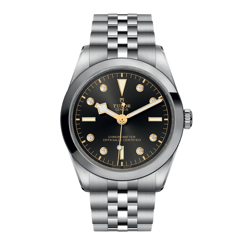 The TUDOR Black Bay One 36 is a stainless steel wristwatch featuring a black dial, gold hour markers, diamond accents, and a durable 316L steel bracelet, inspired by the iconic Black Bay models.