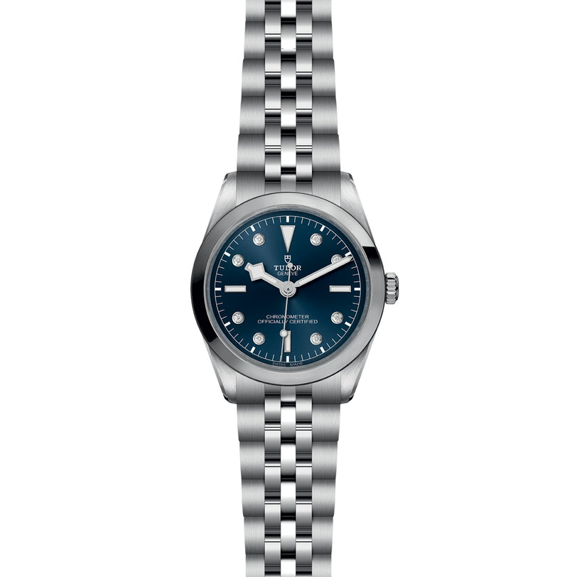 The TUDOR Black Bay One 36 is a unisex stainless steel watch with a blue dial, silver hour markers, and a jubilee-style bracelet, featuring the TUDOR rapid adjustment system inspired by classic Black Bay models.
