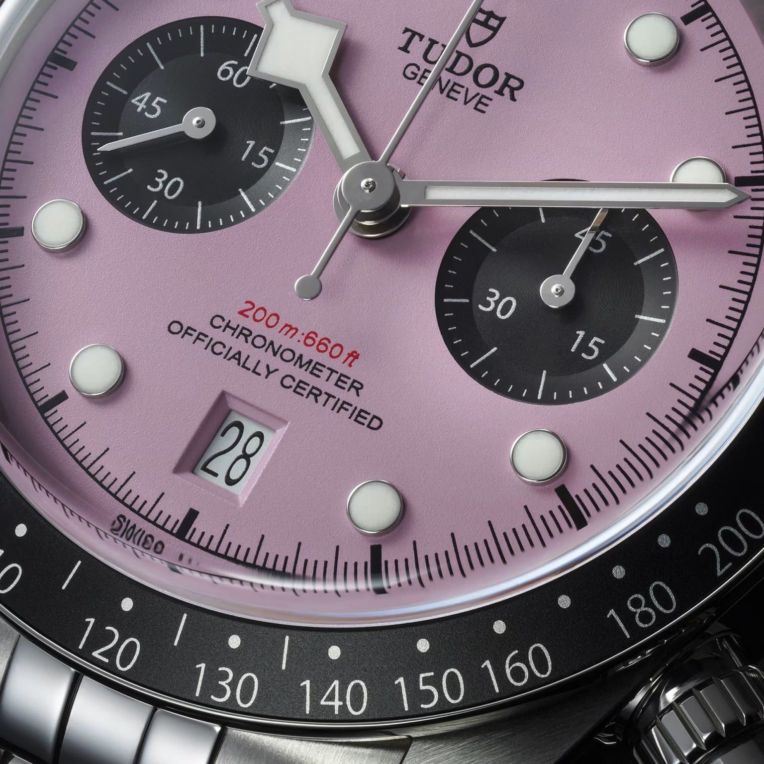 Close-up of the TUDOR Black Bay Chrono, showing its bold pink dial, black subdials, date at 6 o’clock, and stainless steel case. Swiss Chronometer Certified with 200m (660ft) water resistance.