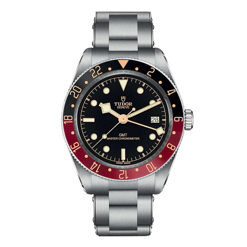 The TUDOR Black Bay 58 GMT is a stainless steel dive watch with a black dial, red and blue bezel, date window at 3 o’clock, and a sturdy metal bracelet.