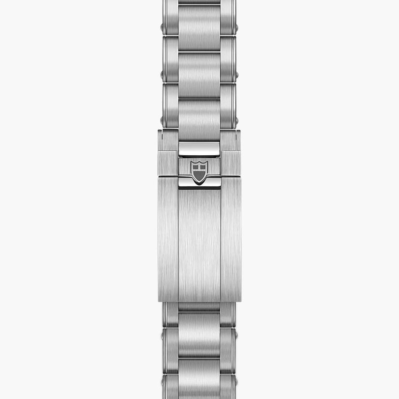 Close-up of the TUDOR Black Bay Pros stainless steel bracelet featuring the brands shield logo on the clasp.