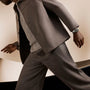 Black Bay 58 watch worn on wrist with dark suit jacket and gray undershirt.
