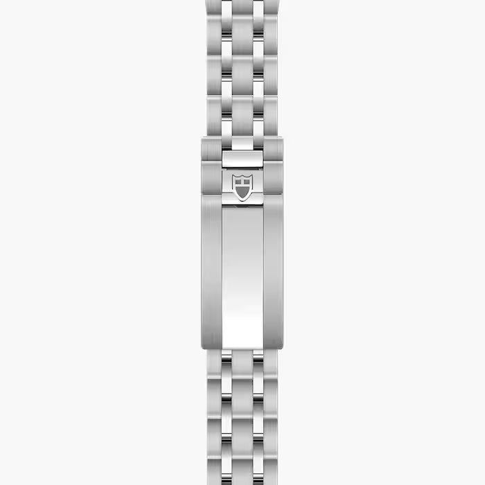 Silver stainless steel watch bracelet with linked segments and shield-shaped clasp featuring Tudor logo.