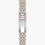 Two-tone steel and gold watch bracelet with shield logo clasp, laid flat vertically.