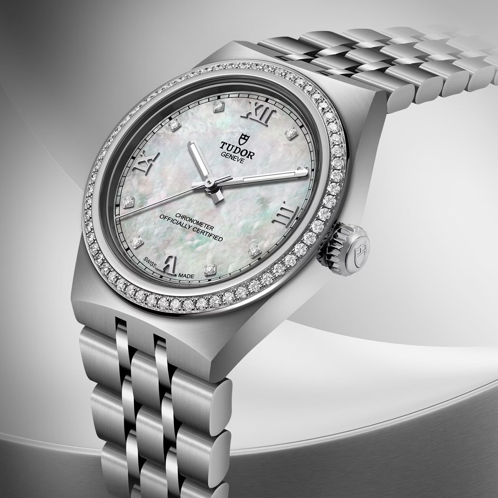 TUDOR Royal stainless steel watch with mother-of-pearl dial, diamond bezel, and two-tone bracelet.