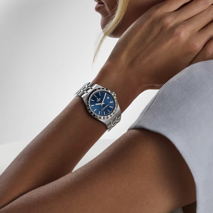 TUDOR Royal watch with blue dial and stainless steel bracelet worn on wrist.