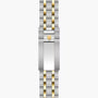 Two-tone stainless steel and gold watch bracelet with shield logo clasp, displayed flat.