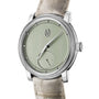 The Parmigiani Fleurier TORIC Petite Seconde is a luxury wristwatch with a light green dial, beige leather strap, and minimalist hour markers.