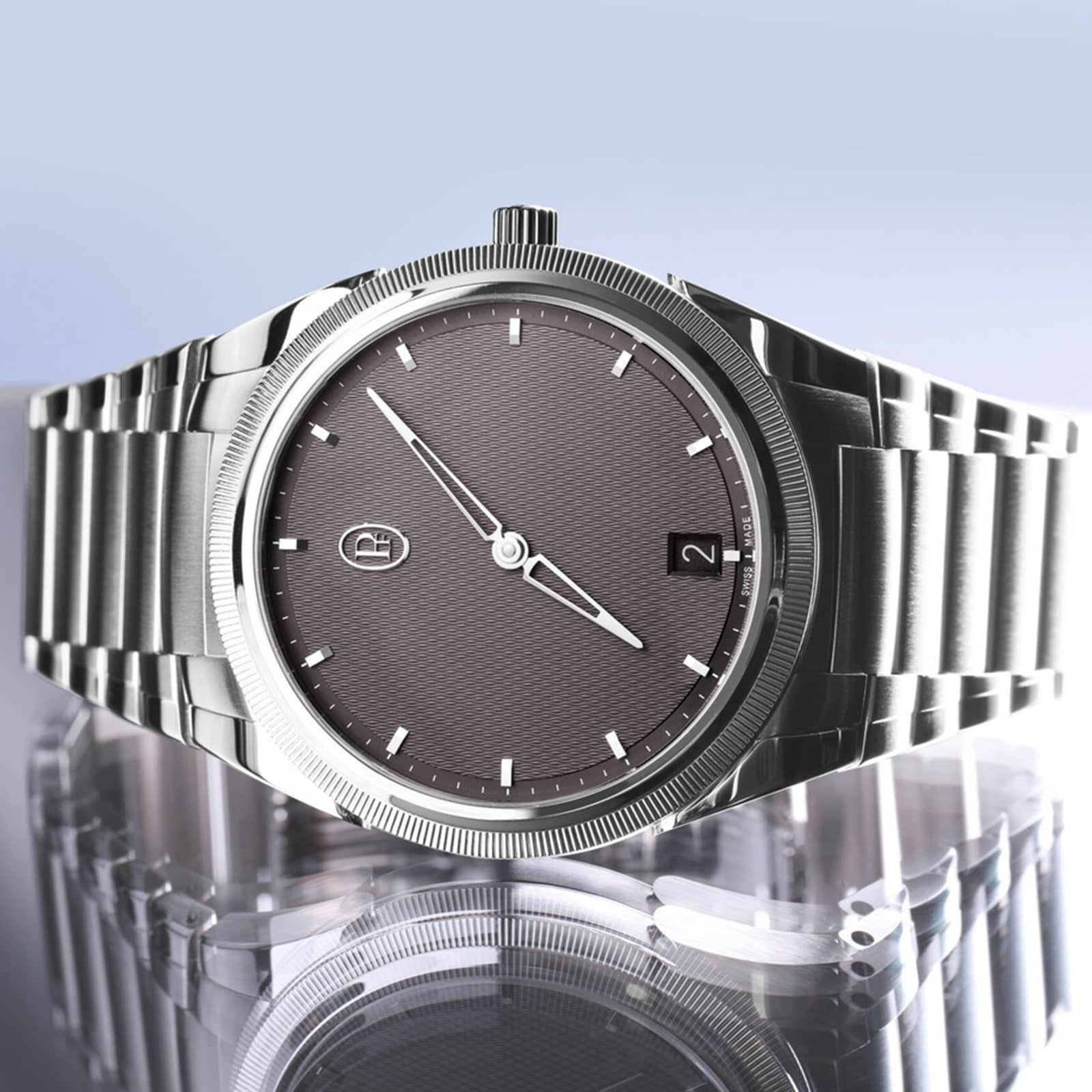 The Parmigiani Fleurier TONDA PF Micro-Rotor is a silver luxury wristwatch featuring a gray dial and date display, beautifully reflected on a shiny surface.