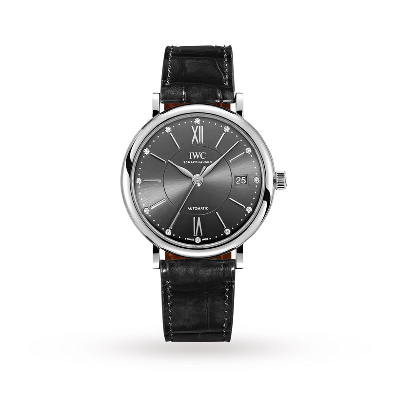 The IWC Schaffhausen Portofino Chronograph is an elegant ladies’ watch with a round black dial, silver hands, Roman numerals at 12 and 6, a date display at 3 o’clock, and a classic black leather strap.