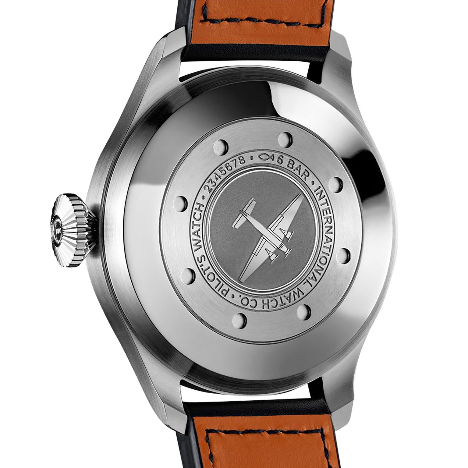 The image shows the back of an IWC Schaffhausen Big Pilots Watch with an engraved airplane design and text on stainless steel, paired with a brown leather strap featuring visible stitching.