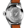 The image shows the back of an IWC Schaffhausen Big Pilots Watch with an engraved airplane design and text on stainless steel, paired with a brown leather strap featuring visible stitching.