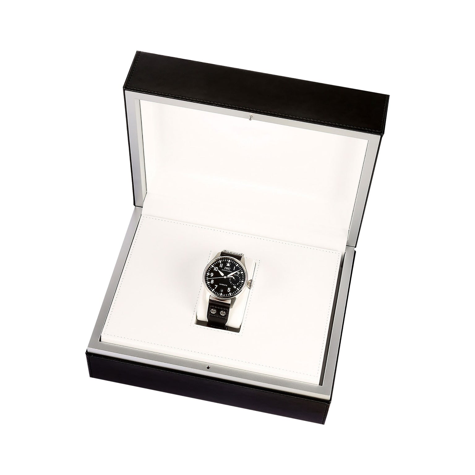 The IWC Schaffhausen Big Pilots Watch features a black dial and metal band, elegantly presented in an open black and white box against a white background.