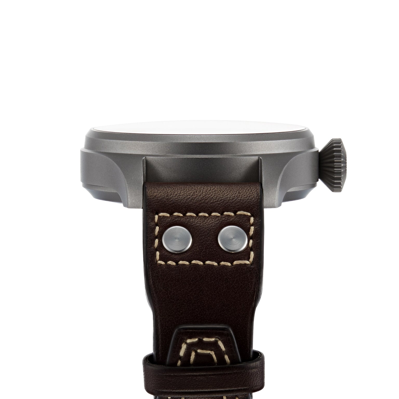 Side view of the IWC Schaffhausen Big Pilots Watch Heritage, showcasing its round titanium case, prominent crown, and brown leather strap with visible stitching and metal rivets.