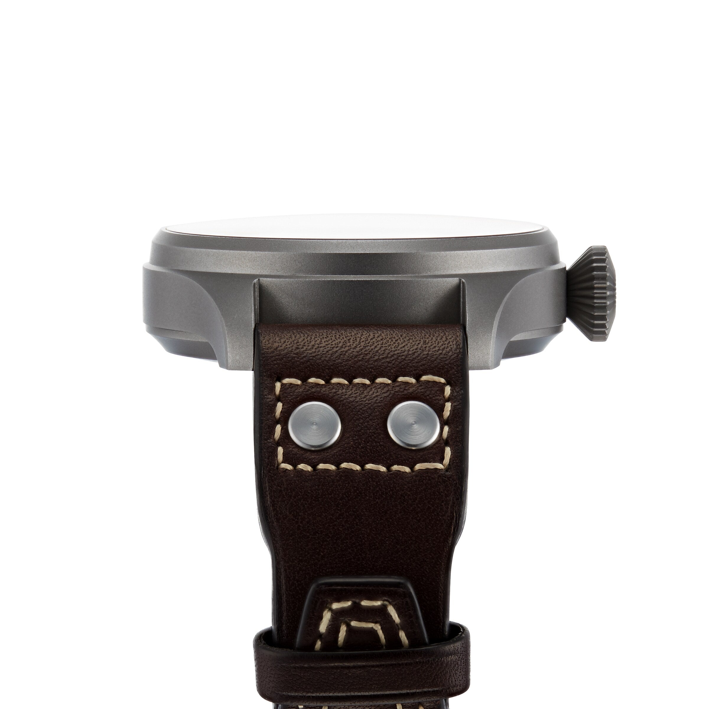 Side view of the IWC Schaffhausen Big Pilots Watch Heritage, showcasing its round titanium case, prominent crown, and brown leather strap with visible stitching and metal rivets.